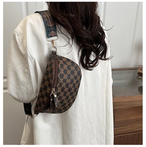 Detailed back view of a vintage crescent sling bag with ethnic pattern wide strap