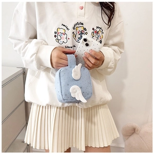 Detail view of light blue starry bag with white angel wings and wide handle grip