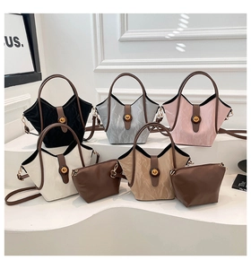 Detailed view of textured bucket bags with luxury gold twist locks and contrasting handles