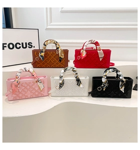 Detailed arrangement of quilted bags in five colors with decorative silk scarves and straps