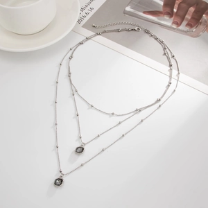 Three-layer silver bead chain necklace with grey square crystal pendants in a chic style