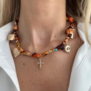 Bohemian silk rope necklace with leopard print heart and gold cross charms on model