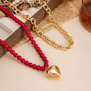 Retro red beaded necklace with gold heart pendant and chunky chain set in a vintage style