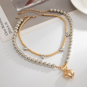 Double-layered beaded necklace with gold heart pendant and silver sphere chain