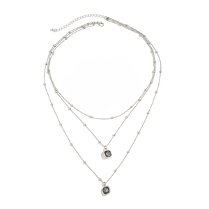 Three-layer silver bead chain necklace featuring two dark grey square crystal pendants
