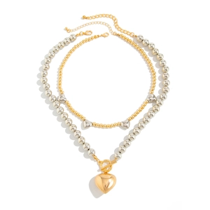 Dual-layer beaded necklace featuring gold heart pendant and silver heart charms with toggle clasp