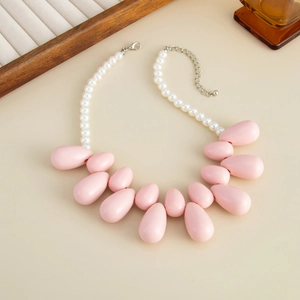 Dettaglio della collana di perle con grandi pendenti a goccia rosa e chiusura regolabile