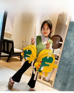 Detail show of toddler yellow dinosaur backpack featuring 3D orange fins and cute cartoon