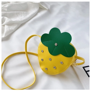 Detail view of yellow strawberry shaped kids crossbody bag with shiny rhinestones