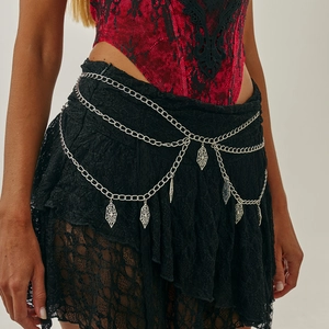 Close-up of gothic silver multi-layer waist chain featuring intricate spider web charms