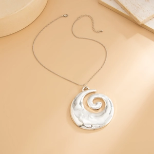 Detail of silver hammered texture shell pendant necklace on minimalist stone base