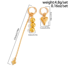 Detail view of gold heart pendant and chain tassel earrings with size measurements