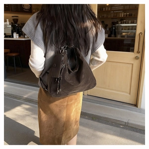 Detail of dark brown matte leather tote bag used as a stylish shoulder bag for commuting