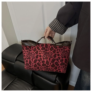 Macro detail of the leopard print and floral rose pattern on a large canvas tote bag