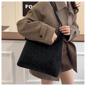 Side view of large black vintage hobo bag on shoulder, perfect for daily commuting
