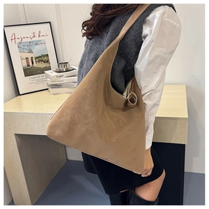 Detail view of khaki minimalist tote bag showing stitching and smooth soft material