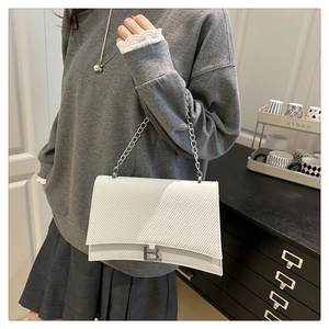 Détail du sac à main blanc sablier avec logo B argenté et bandoulière en chaîne