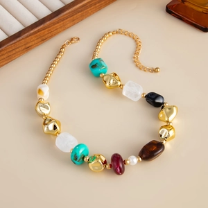 Detail of colorful resin beads and metal pearls on a multi-strand choker necklace