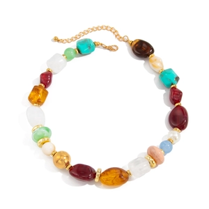 Bohemian colorful resin bead necklace with irregular beads and golden spacers on white backdrop