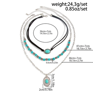 Detail view of 3-layer Bohemian turquoise necklace set with bull head and cross pendants