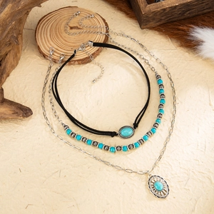 Three-piece bohemian necklace set with turquoise beads, bull pendant, and velvet choker