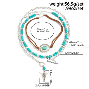 Detailed view of bohemian turquoise bead necklace set with bull head and cross pendant charms