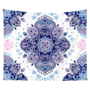 Detail of bohemian mandala tapestry featuring blue and purple paisley patterns on white fabric