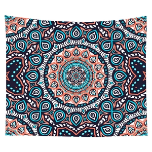 Detail of bohemian mandala tapestry featuring intricate blue and orange symmetrical patterns