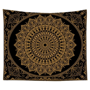 Close-up of bohemian mandala tapestry with intricate gold geometric patterns on black fabric