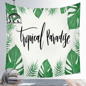 Detail of tropical plant tapestry showing Monstera leaves and Tropical Paradise text