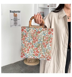 Detail of floral embroidery fabric and vintage bamboo handle on this stylish tote bag