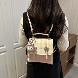 Pink and beige checkered women backpack with a star buckle and plush bear pendant