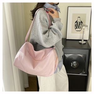 Detail of spacious pink waterproof nylon tote bag with adjustable shoulder strap