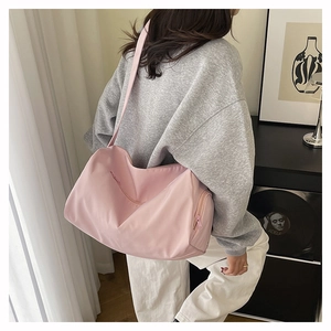 Pink quilted shoulder bag with large capacity shown in a minimalist home setting