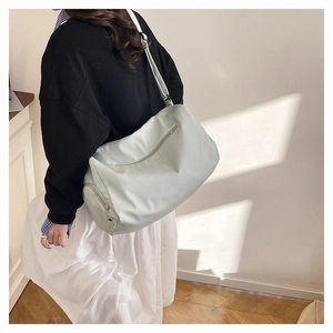 Detail of mint green fashion tote bag with smooth texture shown in natural light
