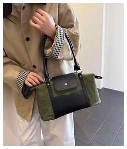 Detail shot of the military green canvas and black leather strap on this large tote bag