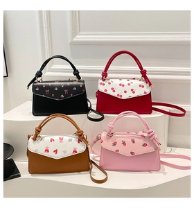 Detail view of four small crossbody bags featuring floral, cherry, and bear prints