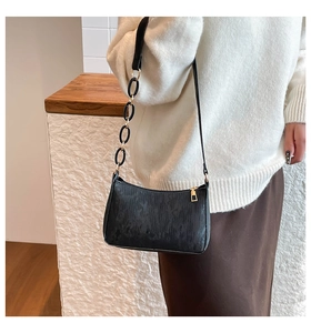 Detail of jacquard baguette bag with resin chain strap and metallic zipper closure