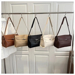 Detail view of stylish minimalist handbags in five colors displayed on a metal rack