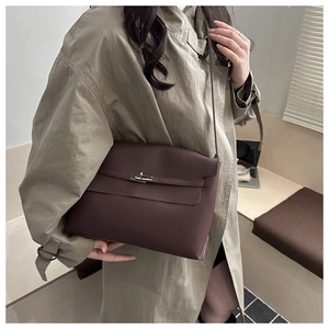 Close-up of a classic dark brown leather handbag with a metal twist lock and flap closure