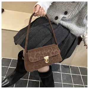 Détail du sac bandoulière léopard vintage avec fermoir doré et texture en daim doux