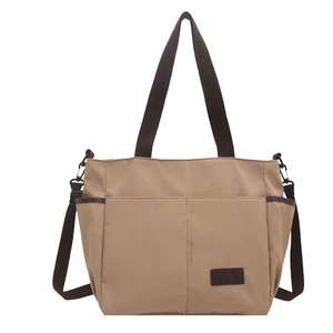 Borsa tote minimalista in tela kaki con manici marroni e tasche frontali capienti