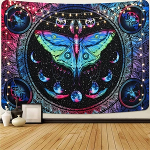 Detail of colorful butterfly mandala tapestry with moon phases and warm string lights