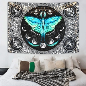 Cozy bedroom scene with a bohemian Luna Moth tapestry featuring moon phases and warm fairy lights