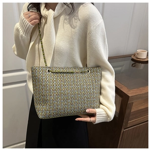 Close-up of colorful tweed texture on a luxury chain crossbody bag with woven fabric