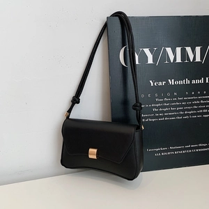 Borsa a spalla baguette nera minimalista con fibbia dorata e base curva elegante