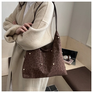 Detailed view of brown leopard print hobo tote bag with gold metal rivet decorations