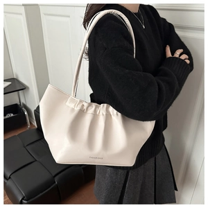Detail of off-white shoulder bag with cloud pleats and Fashion Bags text logo