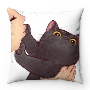 Detail of soft plush cushion cover featuring a cute cartoon cat illustration on white fabric