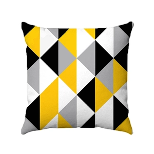 Dettaglio della fodera per cuscino in peluche con motivi geometrici giallo e nero